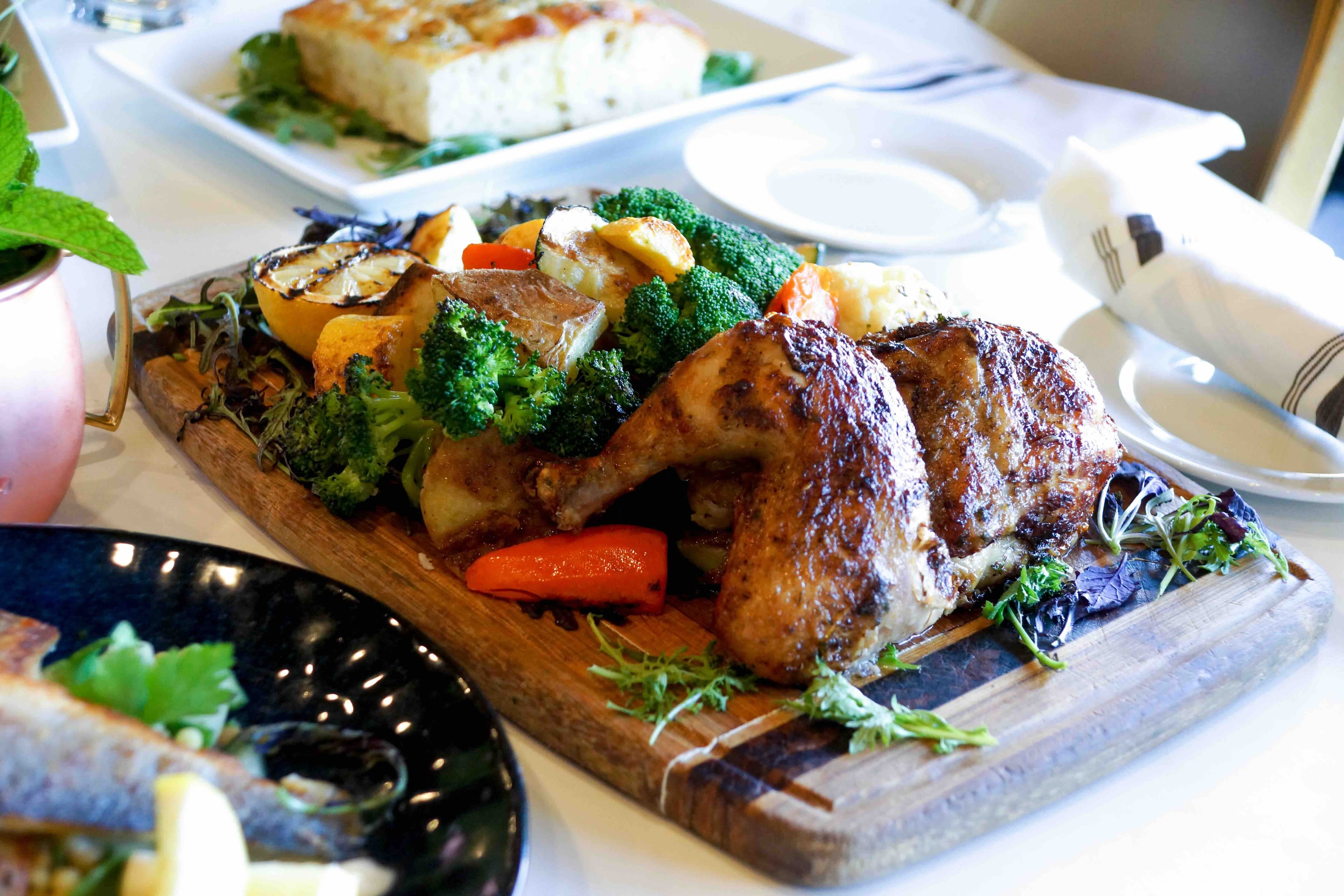 RoVino rotisserie chicken board with roasted vegetables.